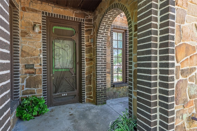 view of exterior entry with brick siding