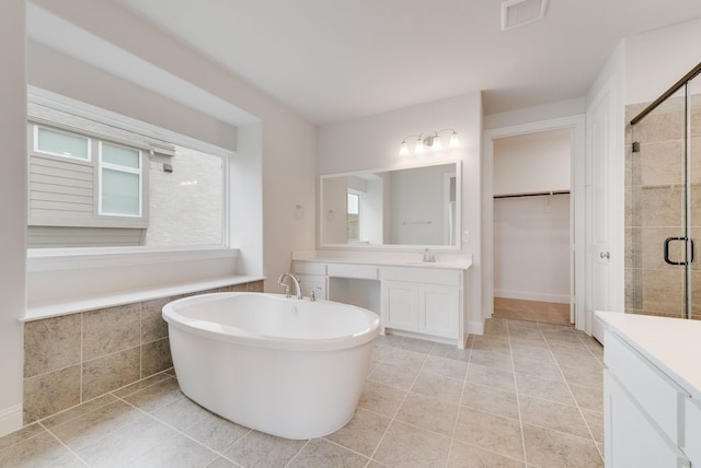 1006 Cascading Creek Dr, Rockwall, TX 75087 - bathroom featuring a stall shower, tile patterned flooring, vanity, and plenty of natural light
