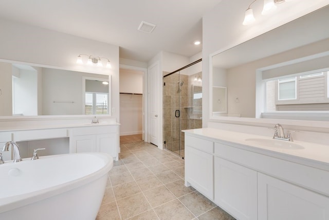 1006 Cascading Creek Dr, Rockwall, TX 75087 - bathroom with a stall shower, tile patterned flooring, a walk in closet, a soaking tub, and two vanities