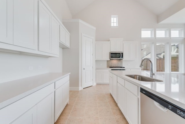 1006 Cascading Creek Dr, Rockwall, TX 75087 - kitchen with dishwasher, a sink, stainless steel microwave, high vaulted ceiling, and light countertops