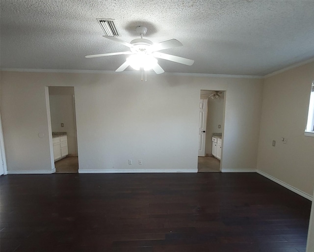 unfurnished room with a textured ceiling, visible vents, a ceiling fan, wood finished floors, and crown molding