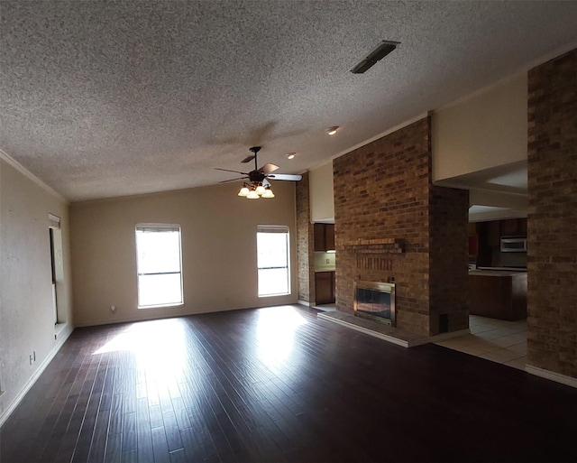 unfurnished living room featuring ceiling fan, vaulted ceiling, a textured ceiling, and visible vents