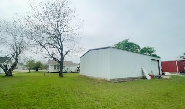 exterior space featuring a garage and an outbuilding