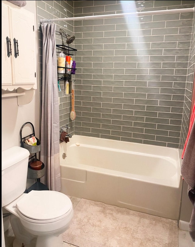 full bathroom with tile patterned floors, shower / bathtub combination with curtain, and toilet