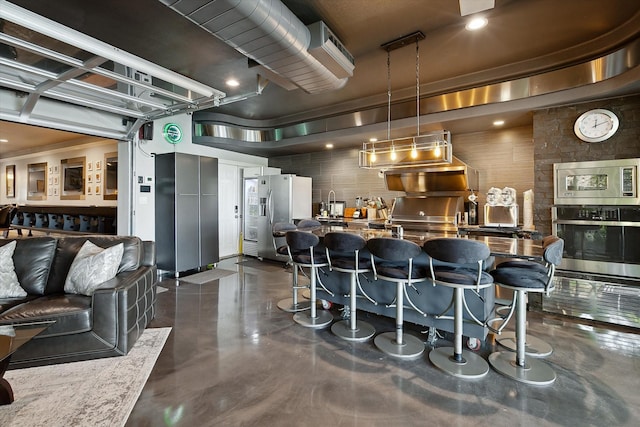 7909 Bal Harbour Ct, Fort Worth, TX 76179 - bar with appliances with stainless steel finishes, finished concrete flooring, pendant lighting, and a sink