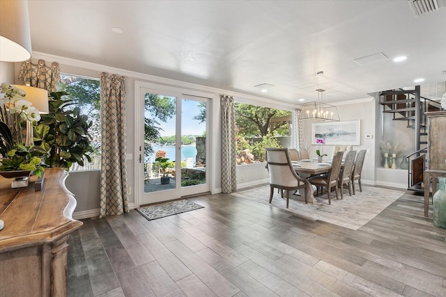 7909 Bal Harbour Ct, Fort Worth, TX 76179 - dining space with crown molding, baseboards, wood finished floors, a chandelier, and stairway