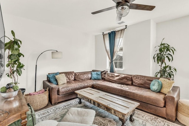 living room featuring visible vents and ceiling fan
