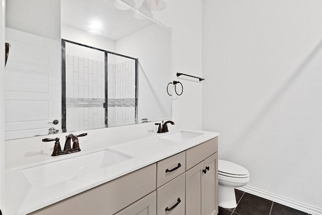 full bath with a shower stall, tile patterned flooring, toilet, and a sink