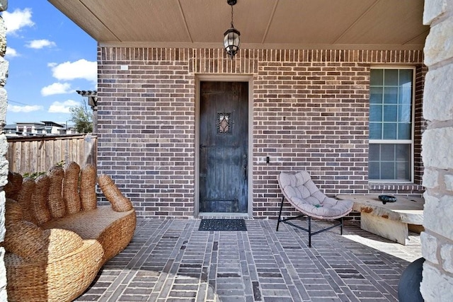 doorway to property featuring brick siding