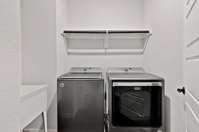 laundry room with washing machine and dryer, a sink, and laundry area
