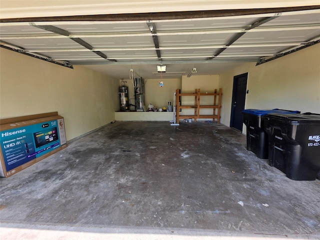 garage with strapped water heater and a garage door opener