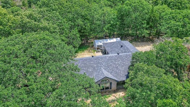 drone / aerial view with a wooded view