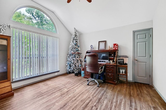 office area featuring a ceiling fan, vaulted ceiling, wood finished floors, and a baseboard radiator