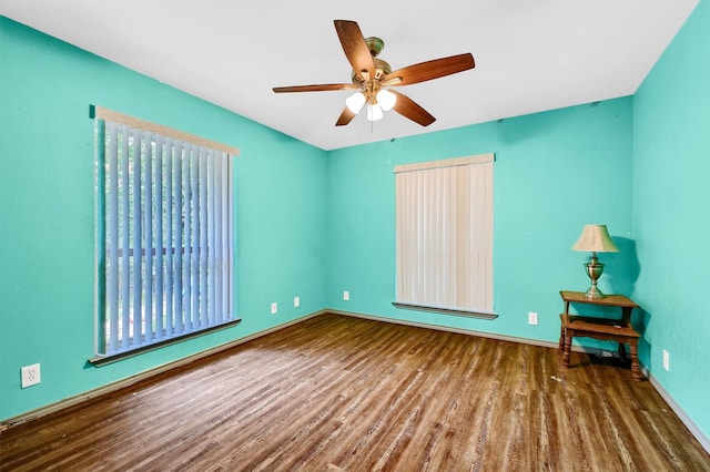 unfurnished room with baseboards, a ceiling fan, and wood finished floors