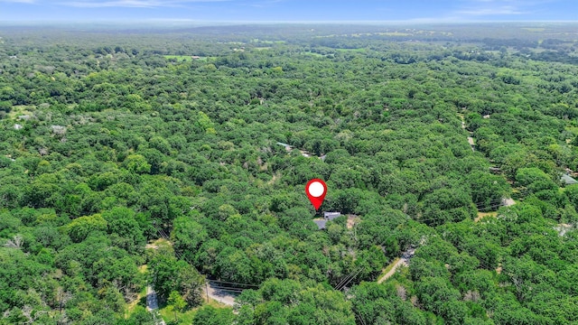 birds eye view of property with a view of trees