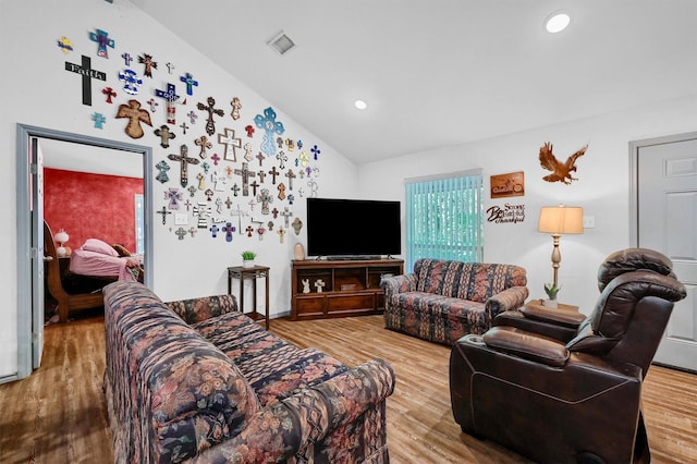 living area with vaulted ceiling, recessed lighting, wood finished floors, and visible vents