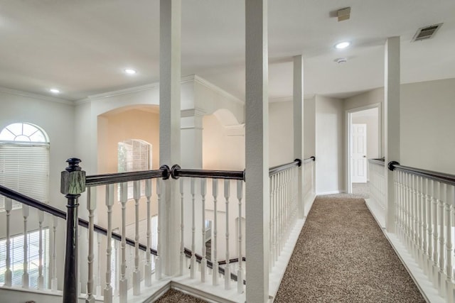 hallway with ornamental molding, an upstairs landing, visible vents, and recessed lighting