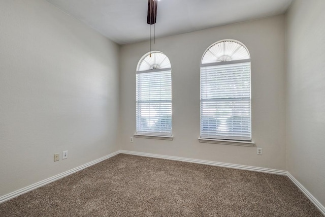 carpeted spare room with baseboards