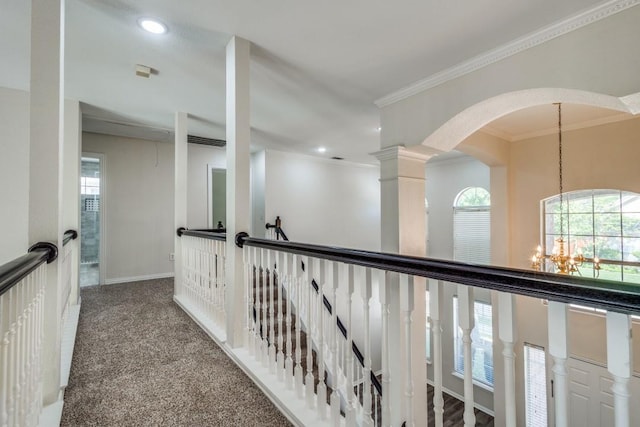 hall with carpet, ornamental molding, a notable chandelier, and recessed lighting