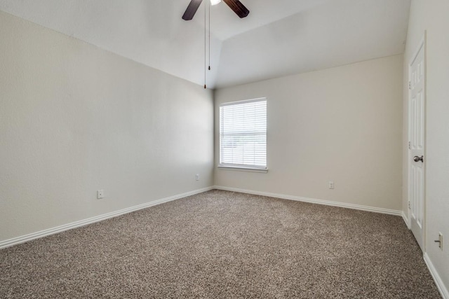 carpeted spare room featuring ceiling fan and baseboards