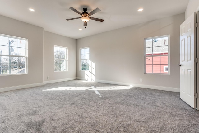 carpeted spare room featuring recessed lighting, a ceiling fan, and baseboards