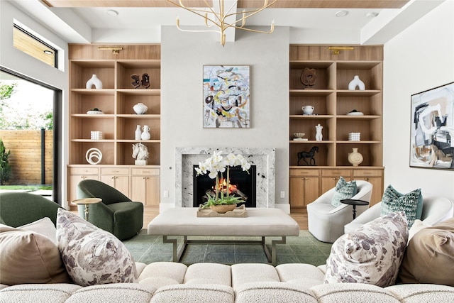 11736 Jamestown Rd, Dallas, TX 75230 - living room with a chandelier, built in shelves, a premium fireplace, and wood finished floors