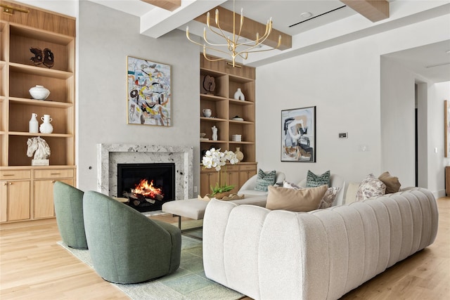 11736 Jamestown Rd, Dallas, TX 75230 - living area with light wood-style floors, a chandelier, a fireplace, and built in shelves