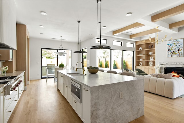 11736 Jamestown Rd, Dallas, TX 75230 - kitchen with a sink, modern cabinets, range, and decorative backsplash