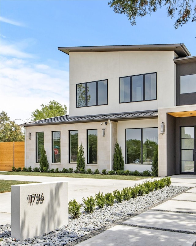 11736 Jamestown Rd, Dallas, TX 75230 - contemporary house featuring a standing seam roof, fence, metal roof, and stucco siding