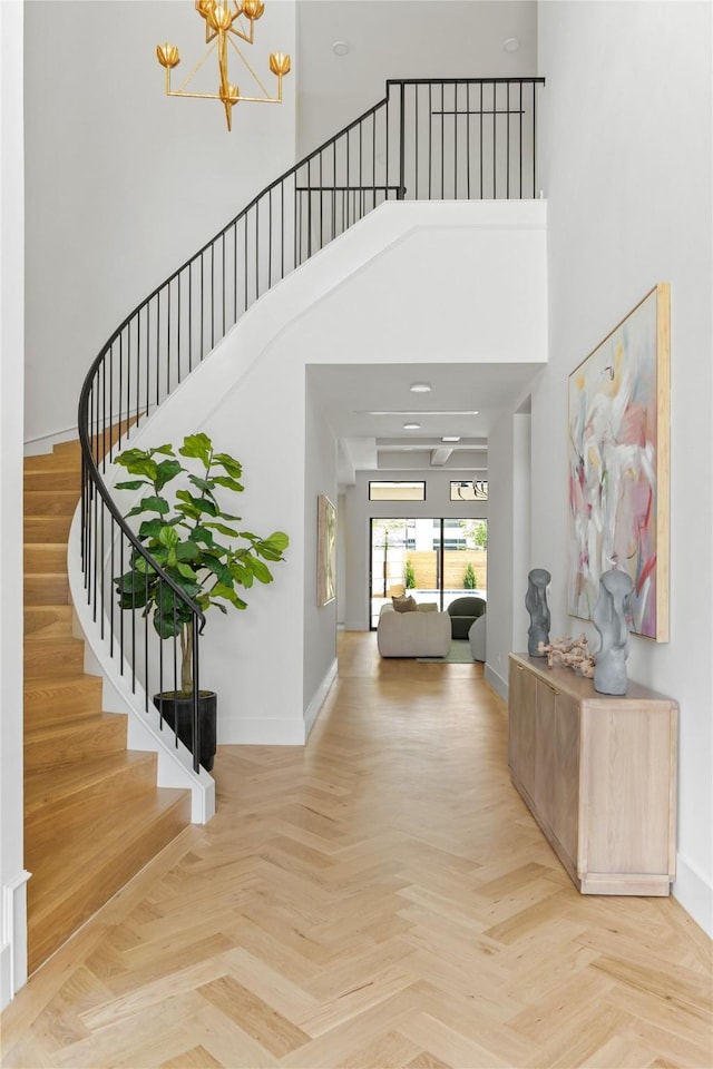 11736 Jamestown Rd, Dallas, TX 75230 - entryway with stairway, baseboards, a towering ceiling, and a chandelier