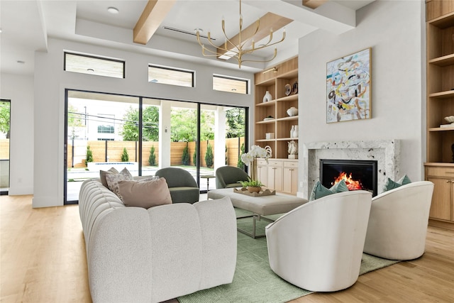 11736 Jamestown Rd, Dallas, TX 75230 - living area with light wood-style floors, a premium fireplace, plenty of natural light, built in features, and beam ceiling