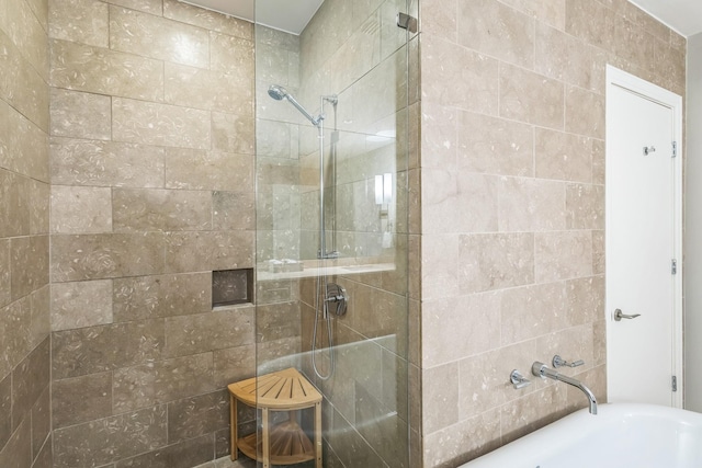 bathroom featuring walk in shower and a tub