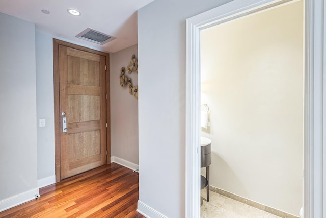 entrance foyer with baseboards, wood finished floors, visible vents, and recessed lighting