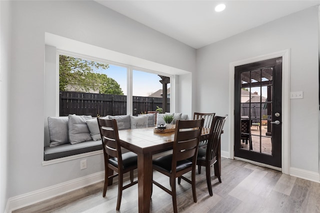 dining room featuring recessed lighting, baseboards, and light wood-style flooring