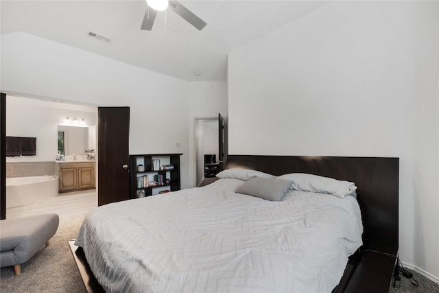 bedroom with vaulted ceiling, a ceiling fan, a sink, connected bathroom, and visible vents