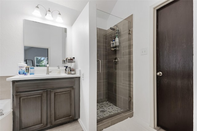 bathroom with a shower stall and vanity