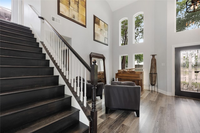 entryway featuring stairway, wood finished floors, visible vents, and plenty of natural light