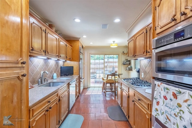 kitchen with recessed lighting, stainless steel appliances, a sink, and backsplash