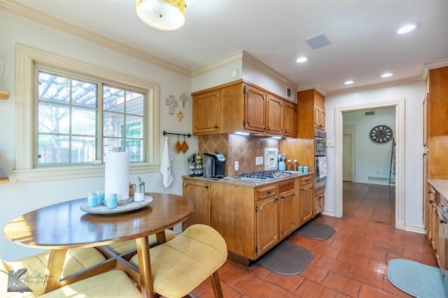 kitchen featuring backsplash, visible vents, stainless steel gas stovetop, and light countertops