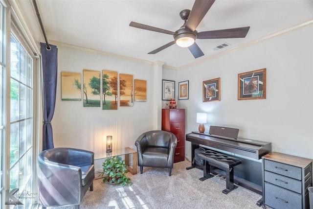 living area featuring visible vents, a ceiling fan, carpet floors, crown molding, and baseboards