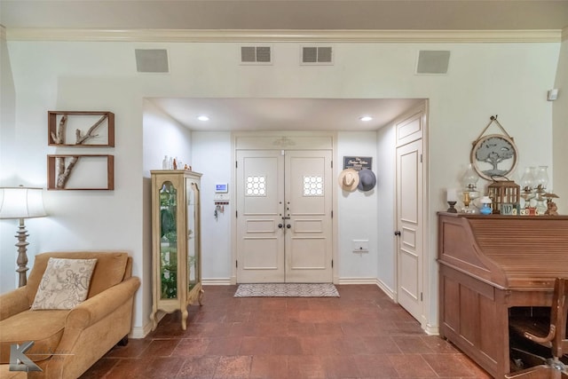 foyer featuring baseboards, crown molding, visible vents, and recessed lighting