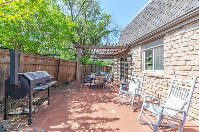 view of patio / terrace featuring a pergola, a fenced backyard, and outdoor dining area