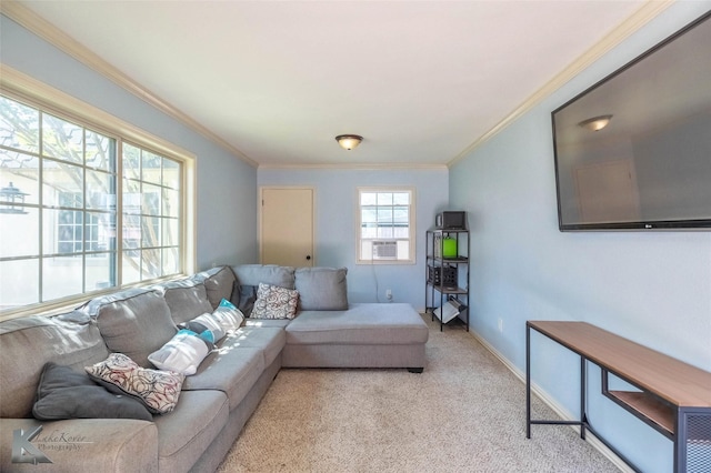 living area with cooling unit, baseboards, light colored carpet, and ornamental molding