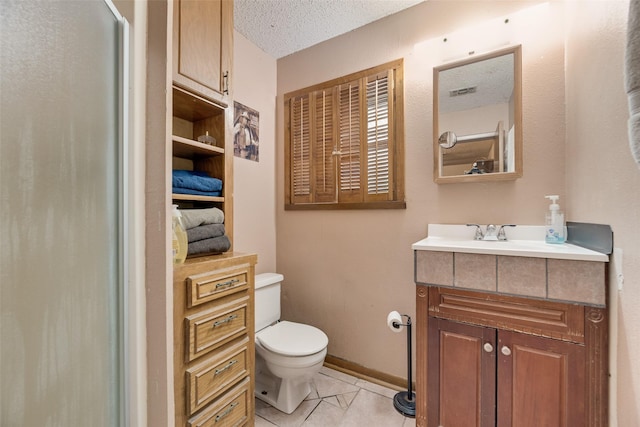 full bathroom featuring tile patterned floors, toilet, vanity, a textured ceiling, and a shower