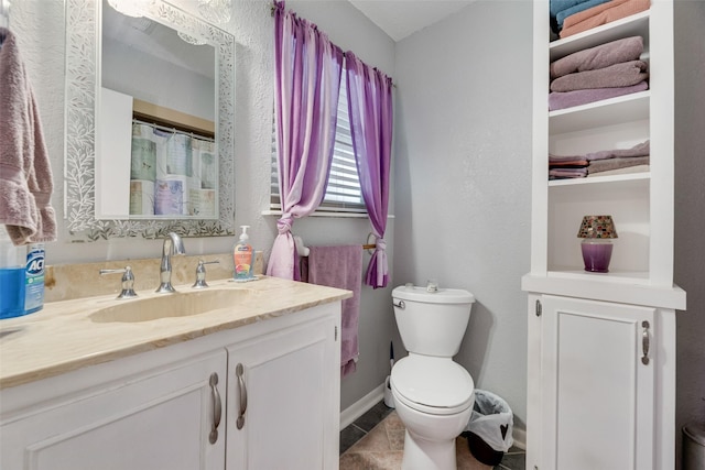 full bath with toilet, vanity, and tile patterned floors
