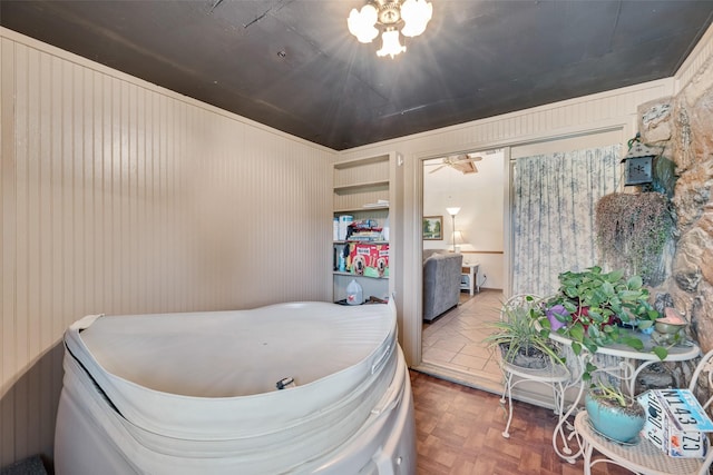 bedroom featuring wooden walls
