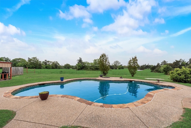 outdoor pool featuring a lawn, a patio, and fence