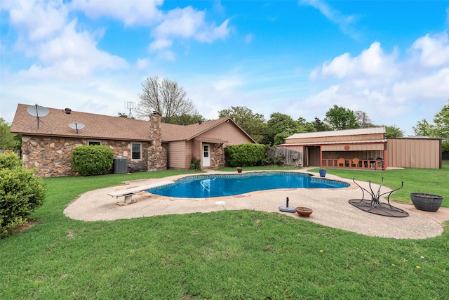 pool featuring a yard, central air condition unit, a patio, and a diving board