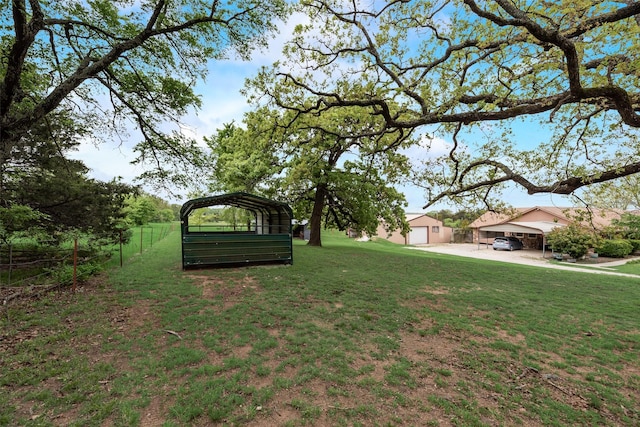 view of yard featuring a carport and fence