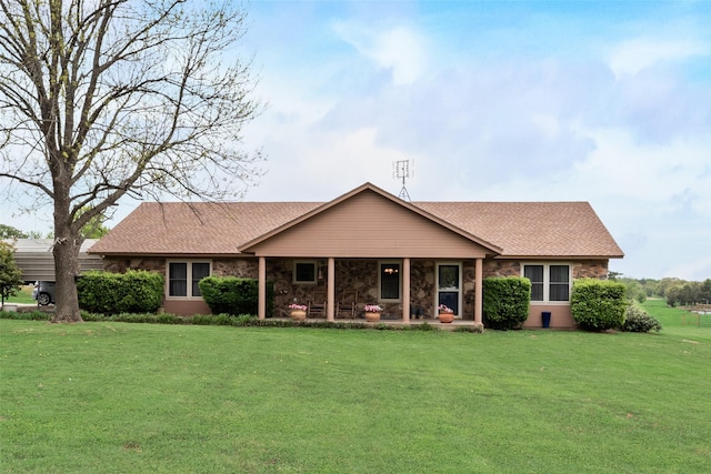 view of front of home with stone siding, a shingled roof, and a front yard